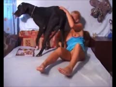 A bored blond causes a dog to occupy her body with its mouth.
